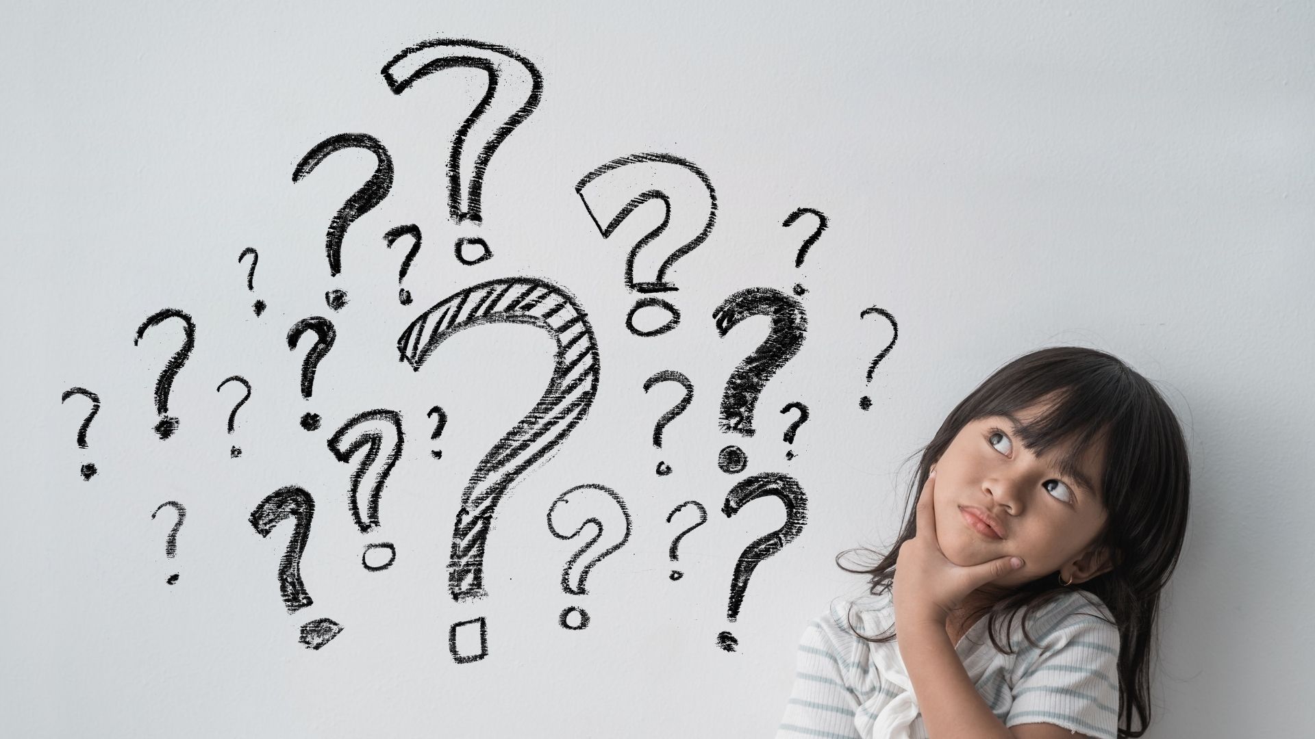 child with question marks above her head