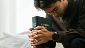 man praying with bible