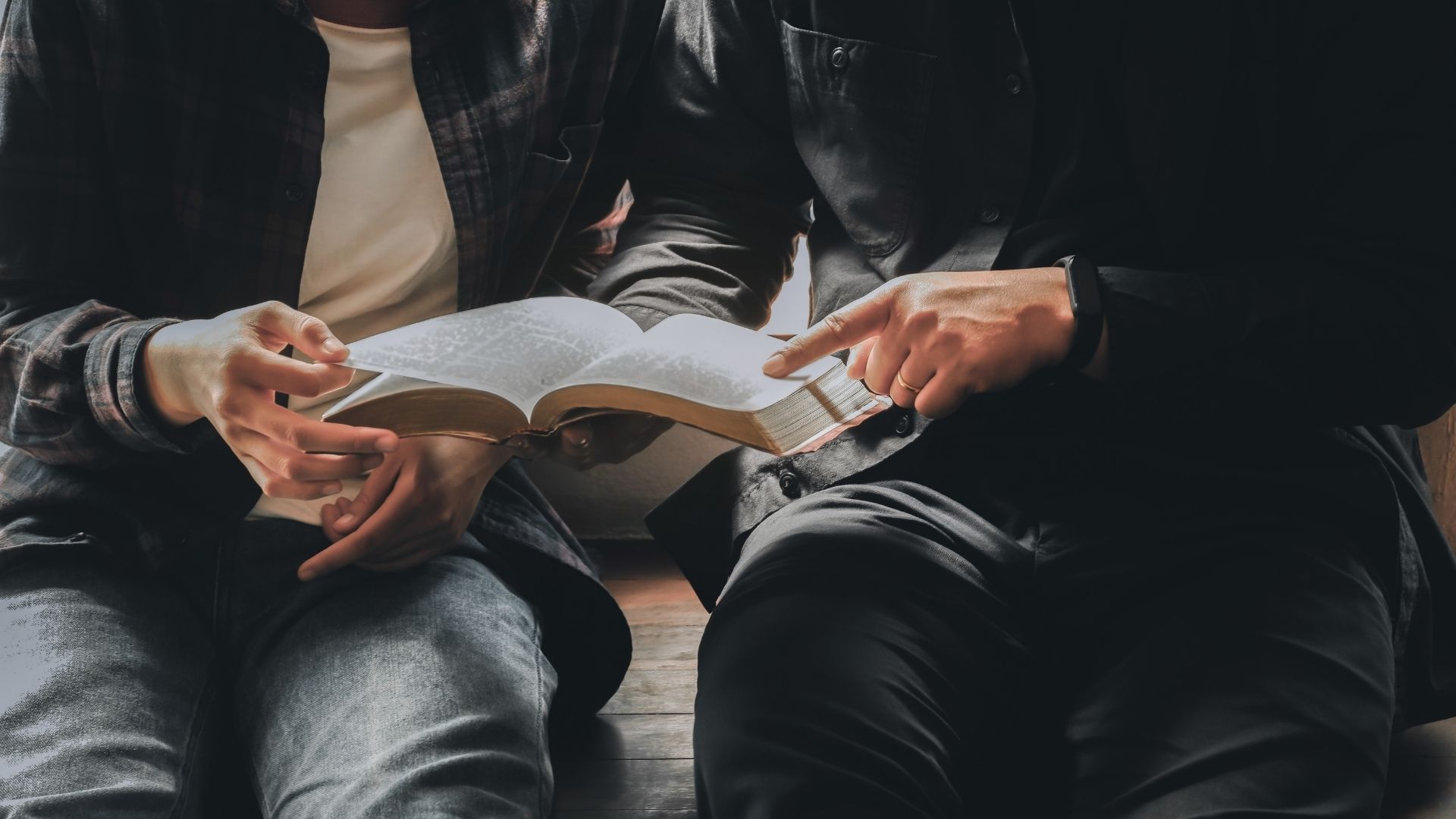 two men reading the bible together