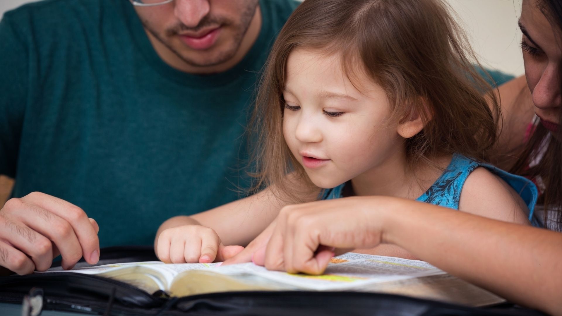 parent reading the bible with a child